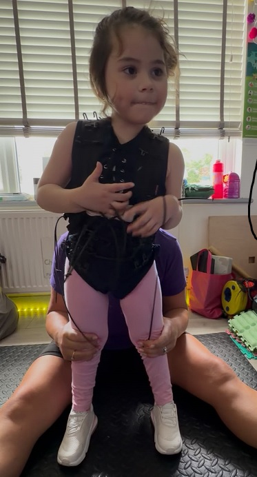 Child wearing the NeuroSuit during physiotherapy
